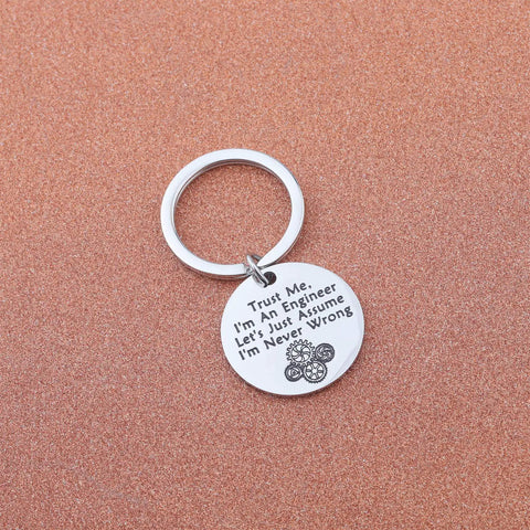 Trust Me I Am An Engineer Keychain With Gear Design on brown background, featuring stainless steel charm and humorous engraving.