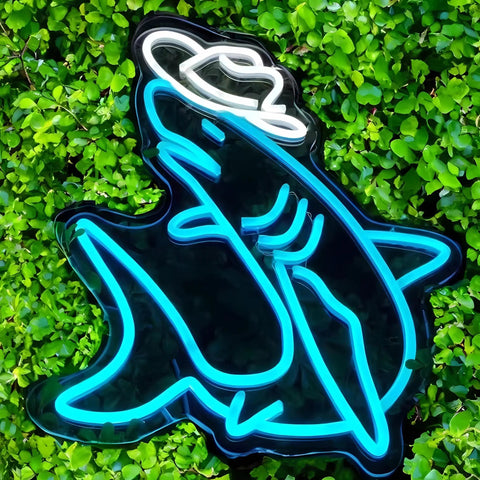 Eye Neon Sign Wall Decor LED Light for Bar and Wedding Parties, glowing shark design with cowboy hat against green foliage