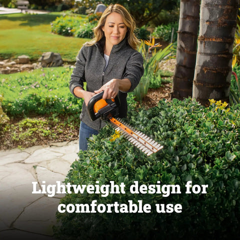 Person trimming hedges with 22 Inch Cordless Hedge Trimmer With Dual Action Blades, Lightweight 5.5 Lbs Yard Tool