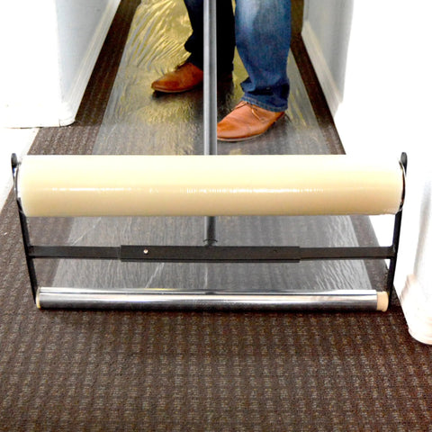 Carpet Film Applicator Workhorse With 36 Inch Roller and 42 Inch Handle on carpet, all steel build, fits large core rolls.