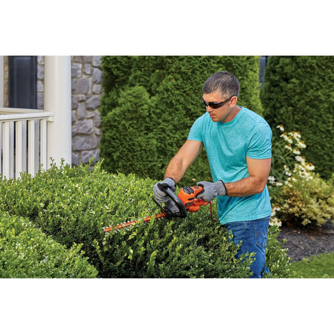 Man trimming hedge with Powerful 3.0 Amp Electric Hedge Trimmer With 16 Inch Blade Lightweight Compact Corded Yard Tool