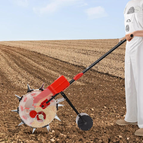 Person using Walk Behind Hand Push Seeder With 10 Equidistant Nozzles For Precise Quantitative Sowing on tilled soil