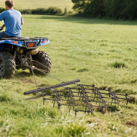 Heavy Duty ATV Chain Drag Harrow 4 Foot Wide By 4 Foot Long With One Half Inch Tines in use on grass field, attached to ATV