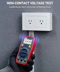Gloved hand using All In One Digital Multimeter For DIYers to test voltage near a wall outlet with NCV safe tester indicator.