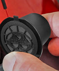 Inserting black refillable coffee pod for OriginalLine machines pack of 6 into red Nespresso compatible device