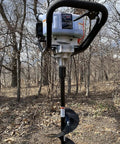 10 Inch Earth Auger Drill Bit, 36 Inch Overall Length, Universal 7/8 Inch Drive Shaft in use with power auger in forest