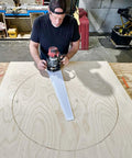 Man using Circle Cutter Router Jig for precise circle cuts from seven to fifty two and three quarters inches on plywood.