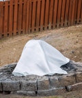Emergency Fire Blanket 40 By 40 Inches covering a fire pit, made of woven fiberglass, ideal for smothering small fires safely outdoors.
