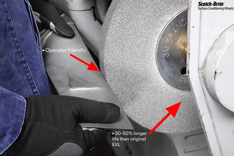 Worker using EXL PRO Deburring Wheel For Metal Finishing And Polishing, Unitized 6 In X 1 In X 1 In, in an industrial setting.