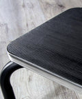 Close-up of non slip platform on heavy duty metal step stool for adults and seniors portable non slip foot stool with 250 lb capacity.