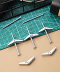 Wing Nut And Toggle Bolt Kit With 20 Metal Drywall Anchors And 1 Eighth Inch Thread Inserts arranged on a green cutting mat.