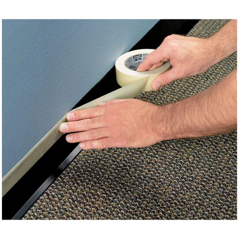 Applying General Purpose Masking Tape Tan 0.70 Inch By 60 Yard Roll For Labeling Painting Bundling And Budget Friendly Everyday Use On Multiple Surfaces With Damage Free Adhesive along baseboard and carpet.