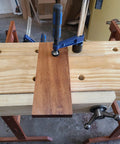 Quick-Adjust Vertical Workbench Hold Down Clamp For Three Quarter Inch Dog Holes, No-Slip Grip, One And A Half Inch Post With Serrations Keeps Thick Workpieces Up To Seven Inches Secure, Cast Zinc Durable Holdfast securing wood piece on bench