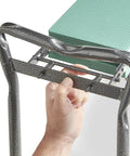Close-up of hand adjusting folding steel frame of 2 In 1 Portable Garden Kneeler Bench And Seat Stool With Tool Bag Accessory, EVA cushion visible