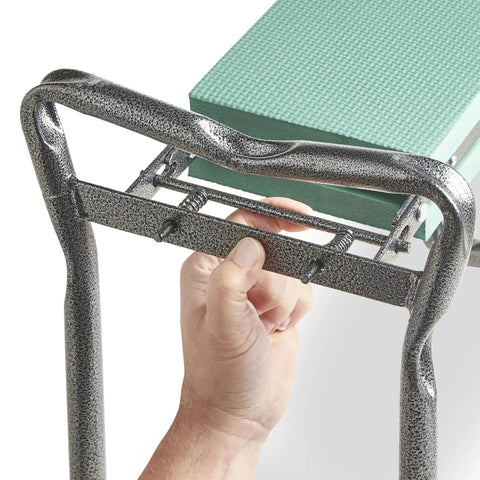 Close-up of hand adjusting folding steel frame of 2 In 1 Portable Garden Kneeler Bench And Seat Stool With Tool Bag Accessory, EVA cushion visible