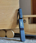 Lumber Wizard 5 metal detector for woodworking, blue handheld unit leaning against a wooden wheeled cart.