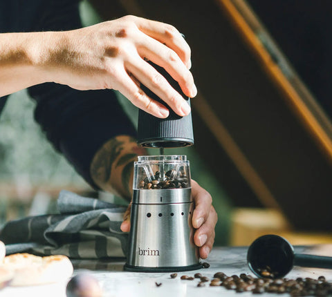Portable Electric Coffee Grinder With Stainless Steel Burrs And Nine Precision Settings For Espresso To French Press Compact design in use.