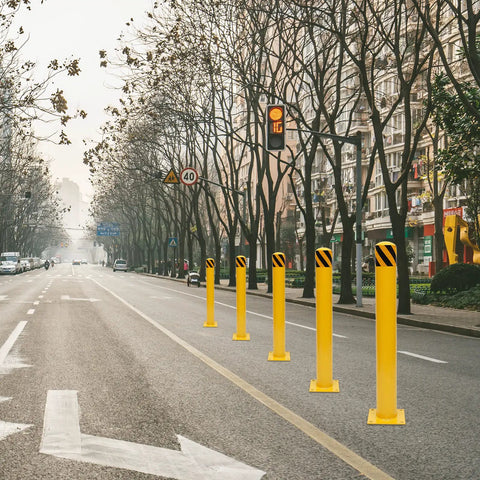 Beefy Yellow Bolt Down Safety Bollard Post 36 Inch Steel Barrier Pillars in a row on a city street for traffic security