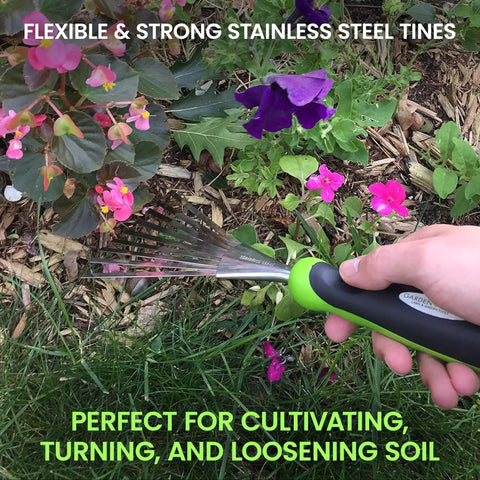 Person using Stainless Steel Hand Rake With Ergonomic Handle For Gardening, Soil Tilling And Cultivating, in a flower bed.