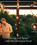 Couple under a pergola with solar powered LED outdoor string lights 27 ft warm white Edison bulbs for patio backyard porch.