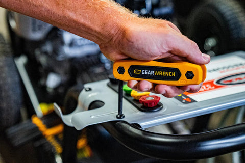 Using 25 Piece SAE Metric Torx Folding Hex Key Set With 270 Degree Rotation for tightening a bolt on machinery
