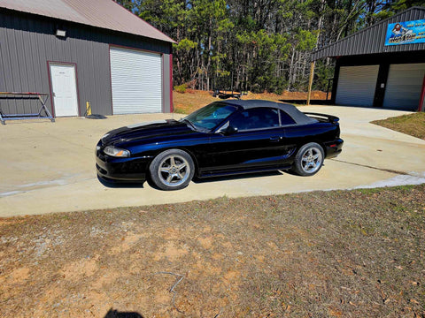 Top Shelf Tinted Blue Paint Basecoat Gallon Ready To Spray With Slow Reducer Blend For Ultra Smooth Automotive Finish That Hits Perfect And Looks Totally Fresh On Any Ride outside a black sports car.