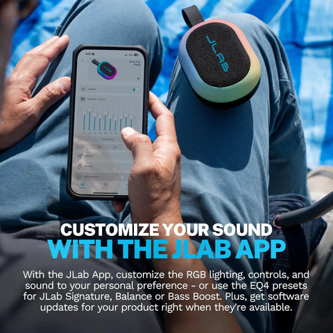 Person holding phone with app next to Portable Bluetooth Speaker Waterproof IP55 With Customizable RGB LED Lights 5W Sound