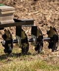 Disc Plow Harrow With Weight Tray for ATV UTV and Garden Tractors shown in garden soil with eight 12-inch notched discs