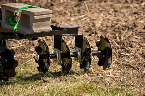 Disc Plow Harrow With Weight Tray for ATV UTV and Garden Tractors shown in garden soil with eight 12-inch notched discs