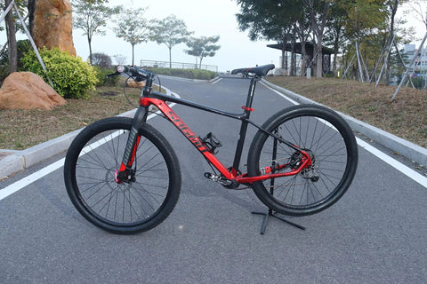 Mountain bike with Rigid Mountain Bike Front Fork Aluminum Alloy 1 1/8 Inch Threadless Straight Steerer Universal Fit 26 27.5 29 Disc Brake 9mm QR Lightweight MTB Front Fork, parked on a road.