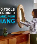 Heavy Duty Drywall Picture Hangers Six Pack Holds Up To 15 Lbs Each With No Studs Required For Hassle Free Room Refresh And Office Display Featuring Sturdy Steel Build For Bold Wall Art with woman hanging mirror.