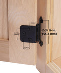 Close-up of Free Swinging Non Self Closing Overlay Face Frame Cabinet Hinges Black 50 Pack 25 Pairs For Kitchen Cabinets Matte Black With Matching Screws And Quiet Bumpers installed on a wooden cabinet, showing dimensions in inches and millimeters.