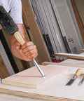 User striking wood with a mallet using the Built Tough 4 Piece Bench Chisel Set For Serious Woodworkers Carved From Top Shelf Chrome Vanadium Steel Blades That Serve Up Knockout Clean Cuts And Hold An Ice Cold Sharpness All Day Long.