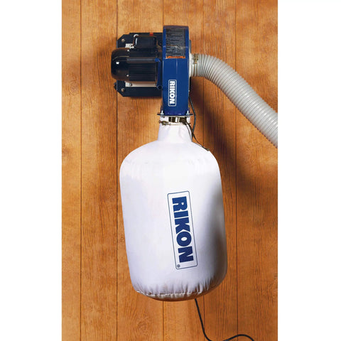 Portable 1 HP Dust Collector For Small Shops No Nonsense With 2 Micron Cloth Bag 660 CFM Performance 4 Inch Dust Port Versatile Woodworking Dust System For Quick Cleanup In Garages And Hobby Shops mounted on wall in garage.