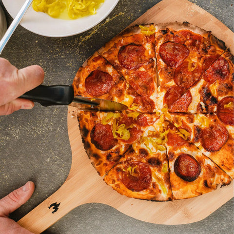 Pizza Cutter Wheel With Durable 304 Stainless Steel Blade And Powder Coated Aluminum Handle slicing pepperoni pizza on wooden board