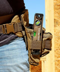Magnetic Box Beam Level For Framing And Layout 10 Inch Torpedo with Tourniquet Bungee in tool belt against wooden frame.