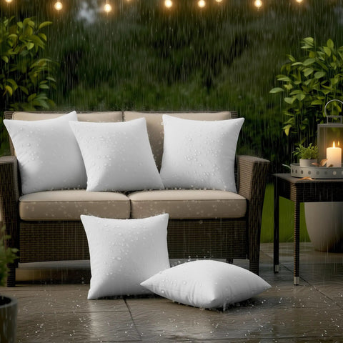 Outdoor Pillow Inserts 18 By 18 Inches Pack Of 2 White No Fuss Water Resistant Throw Pillows For Patio And Porch Furniture Durable Cushions For Garden And Outdoor Decor on a wicker sofa in the rain.