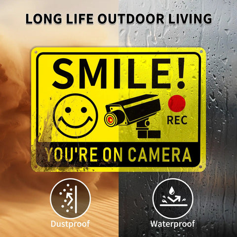 Smile You're On Camera Signs Two Pack Outdoor Video Surveillance Warning Signs 10x7 Rust Free Aluminum UV Printed Weatherproof Security Sign in desert and rain setting