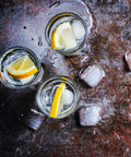 Kick Back Wooden Shooting Board Set With Eighteen Shot Glasses For Chill Game Nights with lemon slices and ice cubes