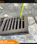 Heavy Duty 32 Inch Manhole Cover Lifting Hook Set, Chrome Plated Solid Steel in use, lifting a storm drain grate.