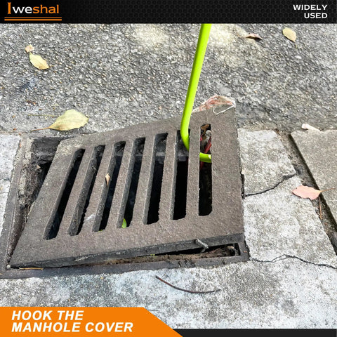 Heavy Duty 32 Inch Manhole Cover Lifting Hook Set, Chrome Plated Solid Steel in use, lifting a storm drain grate.