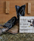 Real Deal 8 Inch Handcrafted Wood Wall Plaque Featuring Cute Cow Live Like Someone Left The Gate Open with cowboy boots