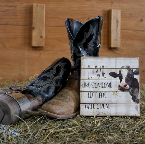 Real Deal 8 Inch Handcrafted Wood Wall Plaque Featuring Cute Cow Live Like Someone Left The Gate Open with cowboy boots