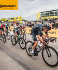 Cyclists racing in a professional road bike event sponsored by Continental, showcasing competition and high-performance bicycles.