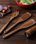 Three Piece Acacia Wood Spatula Set For Cooking, Teethed Pasta Spoon And Spaghetti Fork on wooden surface with salad