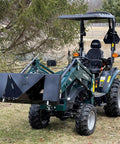 Compact tractor with Beefy Mini Wrecker Stump Bucket For Small Tractors Heavy Duty Tractor Attachment in park setting