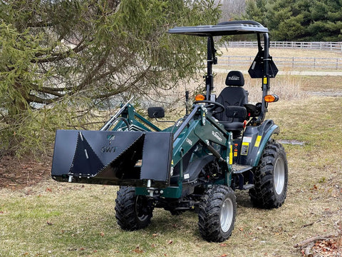 Compact tractor with Beefy Mini Wrecker Stump Bucket For Small Tractors Heavy Duty Tractor Attachment in park setting