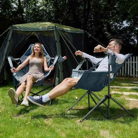 Two people relaxing outside in heavy duty folding hammock chairs with adjustable backrest and padded seat, blue color.