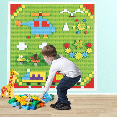 Child playing with Game Changing 812 Piece Building Blocks Kit Featuring Self Adhesive Wall Baseplates And Interconnected Marble Run Tracks.