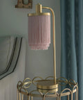 Framboise Fringe Shade Table Lamp With Gold Leaf Finish on a round side table in a living room setting